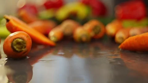 Carrots effectively appear on the table in slow motion. Stock Footage 296362071