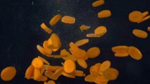 Carrots fall in water Stock Footage 85228175