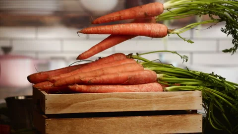 Carrots falling into basket in slow motion Stock Footage 156858654