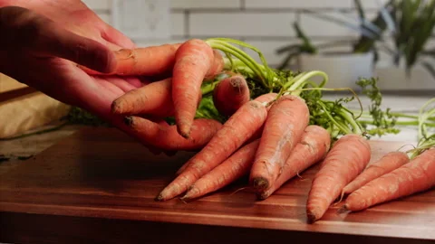 Carrots falling on cutting board in slow motion Stock Footage 156858731