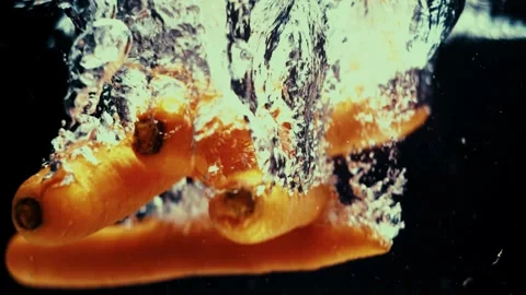 Carrots Float and Fall in Water Stock Footage 300892745
