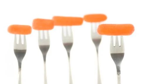 Carrots on forks 2 Stock Photos
