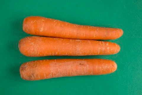 Carrots on green background Stock Photos