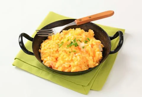 Carrots mashed potatoes in black pan with fork Stock Photos