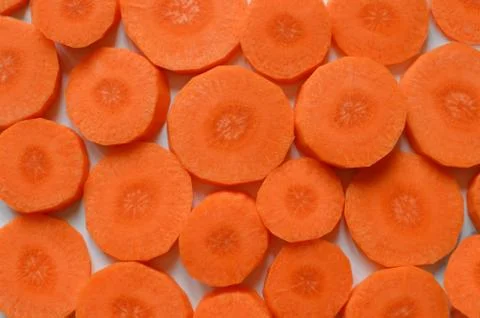 Carrots pattern - chopped raw carrots, round orange pieces make a pattern - s Stock Photos