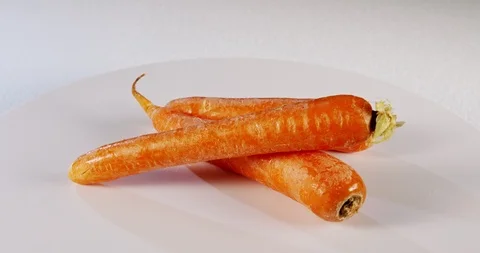 Carrots rotating on white background Stock Footage 125520877