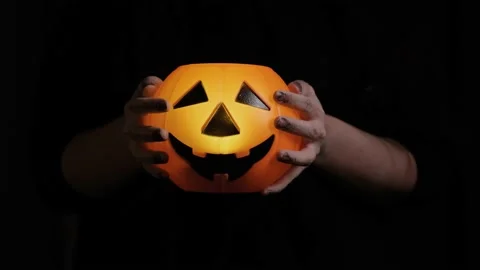 Carry the pumpkin head with your hands disguised as zombies. Halloween attribute Video stock 141899210