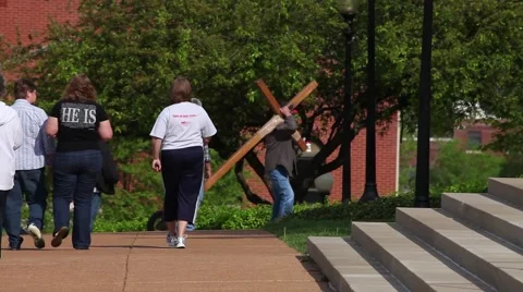 Carrying a Cross on a Wheel in Front of Steps with a Small Crowd Stock Footage 45360674