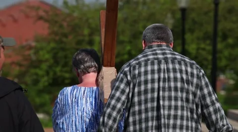 Carrying a Cross on a wheel in a small crowd in front of steps 스톡 동영상 45361589