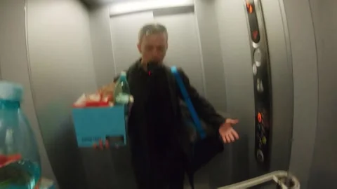 Carrying grocceries in elevator - busy genz influencer Stock Footage 236360511