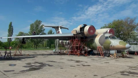 Carrying out work on wing of aircraft Antonov An-72P in camouflage (NATO: Coale Stock Footage 171982503