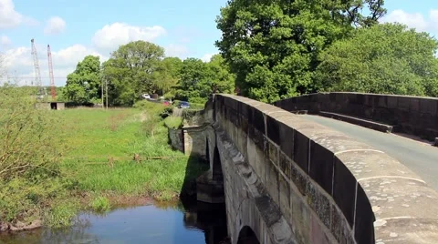 Cars and a bicycle pass across a stone bridge. Stock Footage 63224853