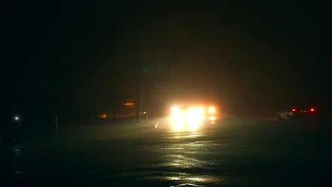 Night Car With Bright Headlights Approaching In The Dark