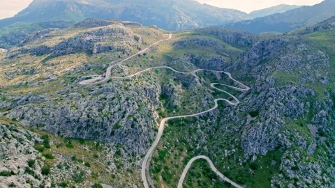 Cars, buses and motorcycles drive on European curved road in Majorca, Spain. Stock Footage
