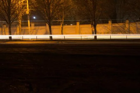 Cars captured by long shutter speeds that leave traces of headlights. Stock Photos