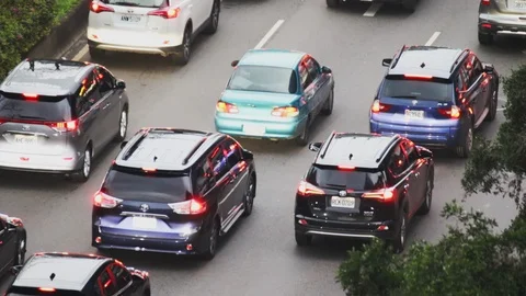 Cars coming to a stop at an intersection during the evening rush hour Stock Footage 107035985