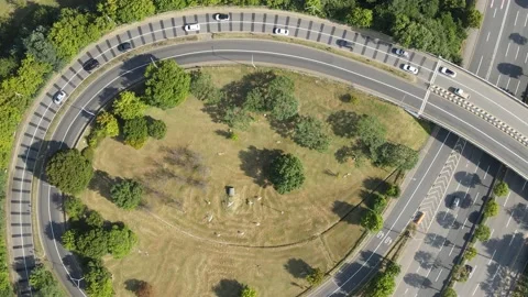 Cars drive along a loop shaped road junction top view. Stock Footage 161253705