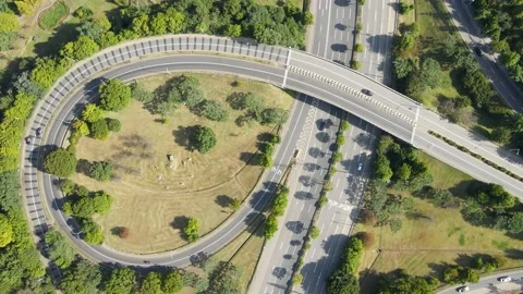 Cars drive along loop shaped road junction aerial view. Stock Footage 161327967