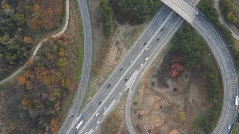 Cars drive along a loop shaped road junction top view. Stock Footage 165393804