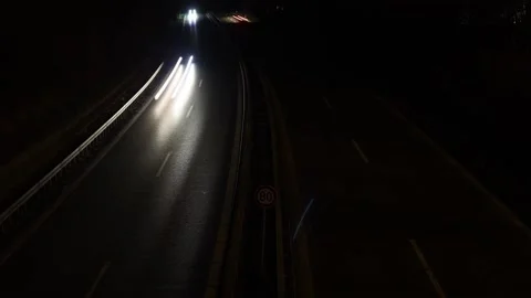 Cars drive along the night road, timelapse. Video stock 238704953