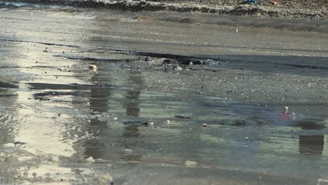 Cars drive in close-up on a bad, bumpy road with pits and puddles. 動画素材 156606284