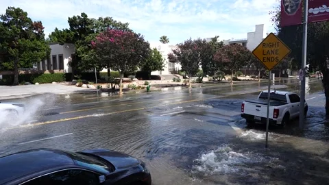 Cars Drive down flooded intersection Stock Footage 340072184