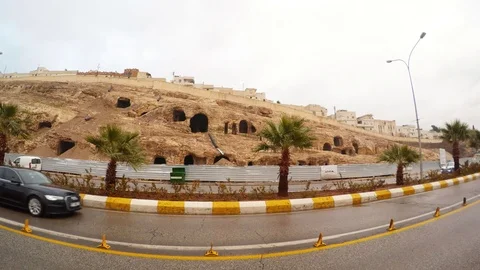 Cars Drive in Front of Camera Empty Anciant Cave City in Centre of Urfa Stock Footage 75409348