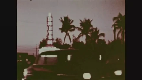 Cars drive-in through the entrance of the movie theater - 1958 Stock Footage