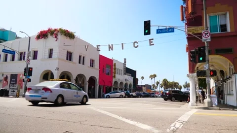 Cars Drive Through Intersection At Venice Beach Slow Motion Stock Footage 302591679