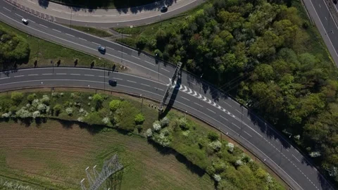 Cars Driving on Complex Highway Interchange Amidst Green Landscape 스톡 동영상 334168247