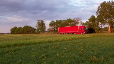 Cars driving on the road between the fields	 in sunset Stockbeeldmateriaal 243512087