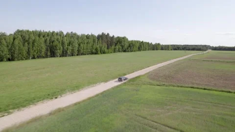 Cars driving on the road between the fields Stock-Footage 243597720