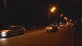 Cars driving slowly on well illuminated street at night, late evening traffic HD Footage