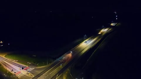 Cars driving through intersection with traffic lights. Vehicles moving across Stock Footage 311933490