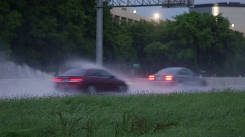 Cars driving through a puddle Stock Footage 49548243