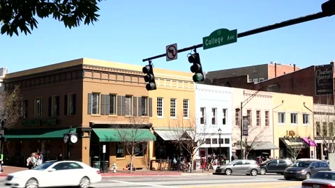 Cars Driving through a Red light in a downtown area Stock Footage