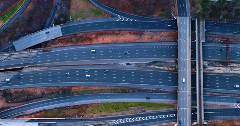 Cars go by the multi-lane parallel highways with bridge and footbridge over them Stock Footage 333512812