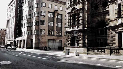 Cars at intersection between old and modern buildings Stock Footage 160216325