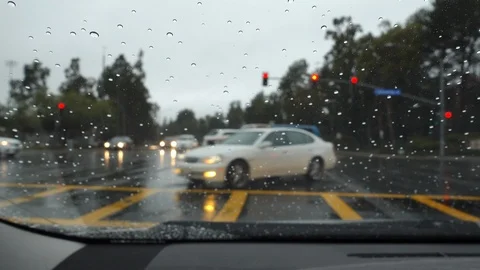 Cars in intersection during rain Stock Footage 105687940