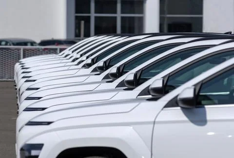 Cars lined up in a regular line Stock Photos