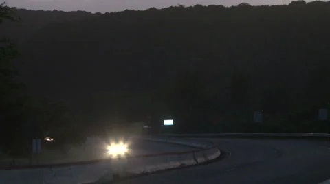 Cars in Mountain Road Downhill at Night Stock Footage