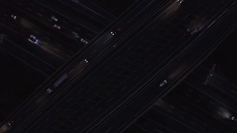 Cars moving on freeway interchange at night Stock Footage 123777260