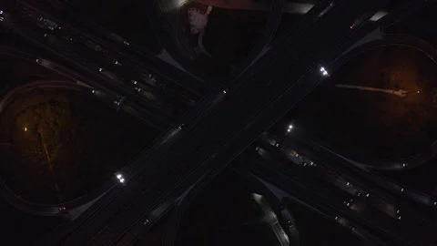 Cars moving on freeway interchange at night Stock Footage 123777668