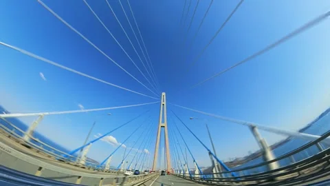 Cars Navigating a Modern Cable-Stayed Bridge Under a Clear Blue Sky. Stock Footage 301171951