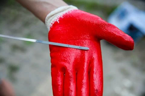 Car's oil dipstick with a red glove. Close up image of vehicle's oil level. Stock Photos