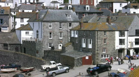 Cars parked at low tide in Port Isaac harbour in Cornwall England. Stock Footage