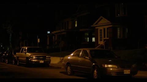 Cars parked outside suburban neighbourhood house at night Stock Footage