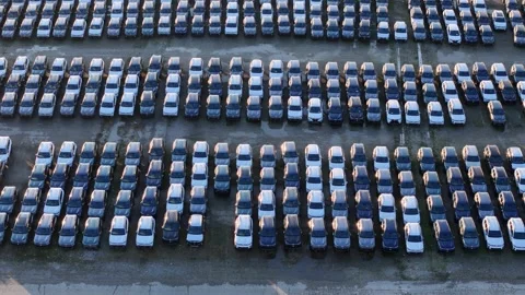 Cars parked in parallel rows inside a logistics storage yard, highlighting Stock Footage 327465278