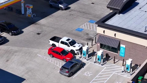 Cars parked at Shell EV charging station in Elyria, Ohio, aerial view Stock Footage 324793369