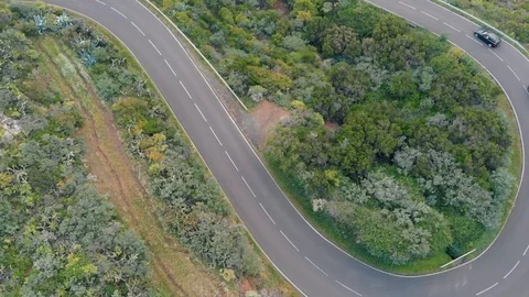 Cars pass a sharp turn of mountain serpentine at high altitude in the mountains 動画素材 109240984